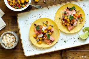 Healthy recipe for salmon tacos with mango and coconut.