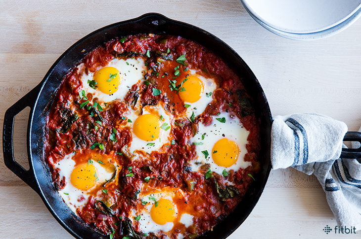 Healthy recipe for shakshuka with poached eggs in a spicy tomato sauce
