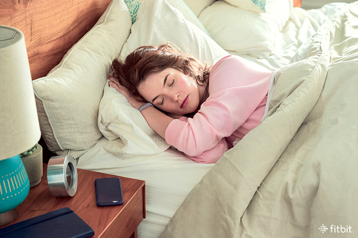 Woman sleeping while wearing Fitbit tracker