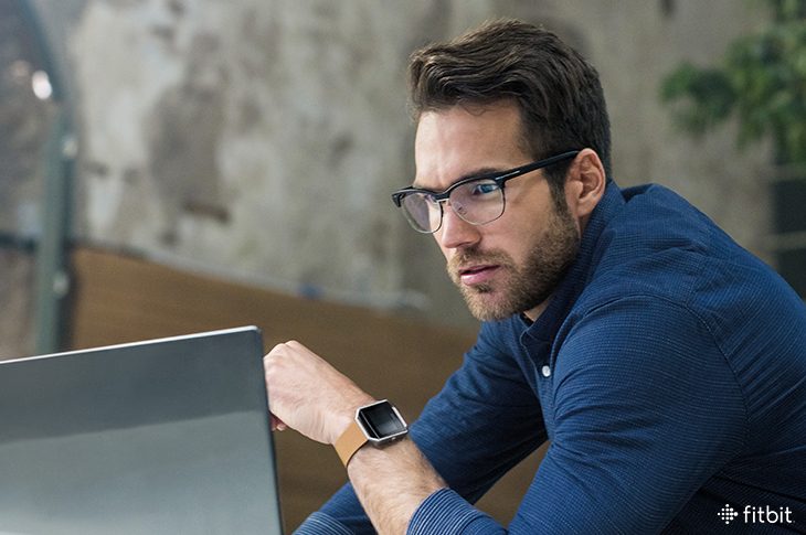 Man in glasses looking at computer