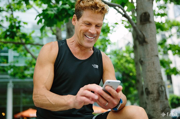 Runner Dean Karnazes checks the Fitbit app