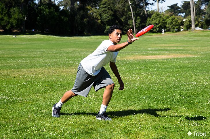 Teen playing frisbee