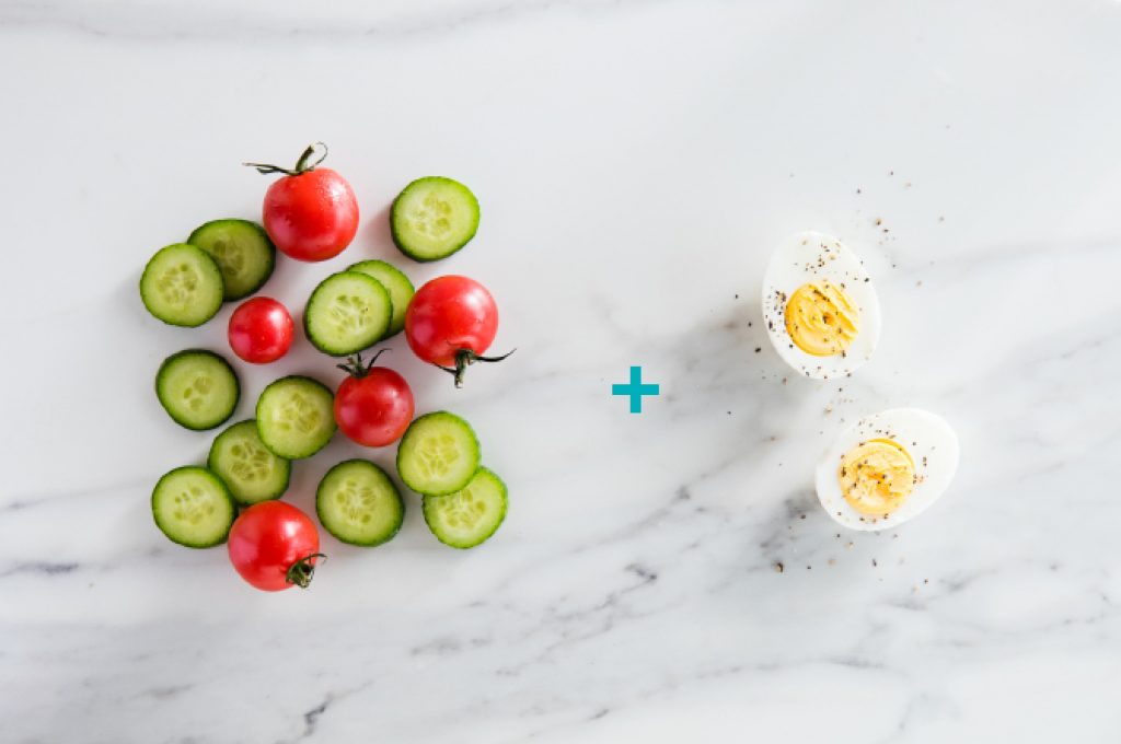 Healthy snack with cucumber, cherry tomatoes, and hardboiled eggs