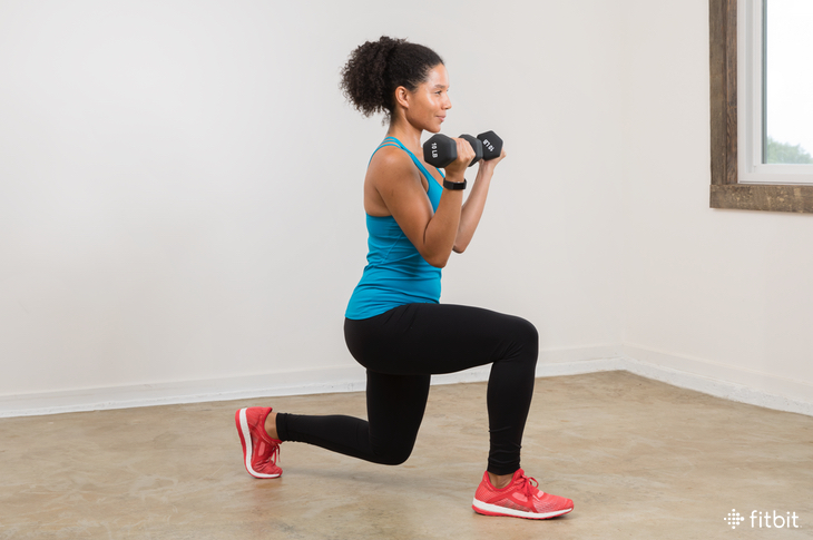 woman doing a dumbbell lunge and curl