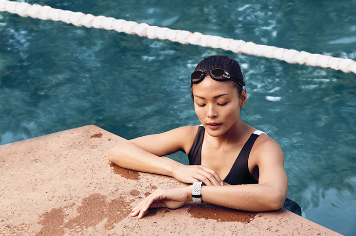 Woman wearing Fitbit Charge 3 in the pool